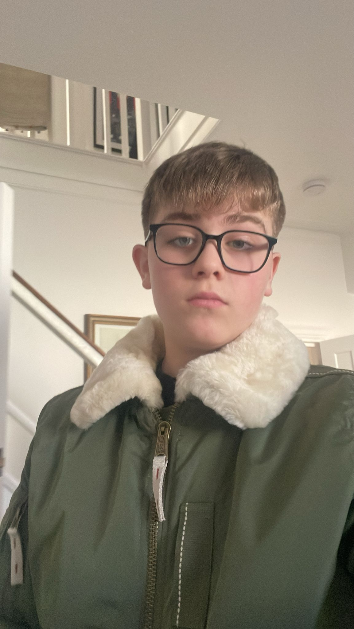 Arthur wearing glasses and a green jacket