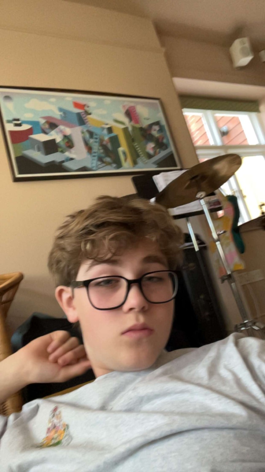 Arthur relaxing with a drum kit behind him